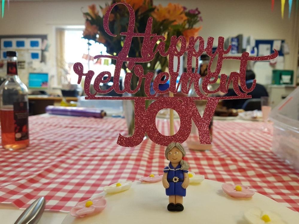 A miniature figure of Joy was created by her colleagues on a celebration retirement cake